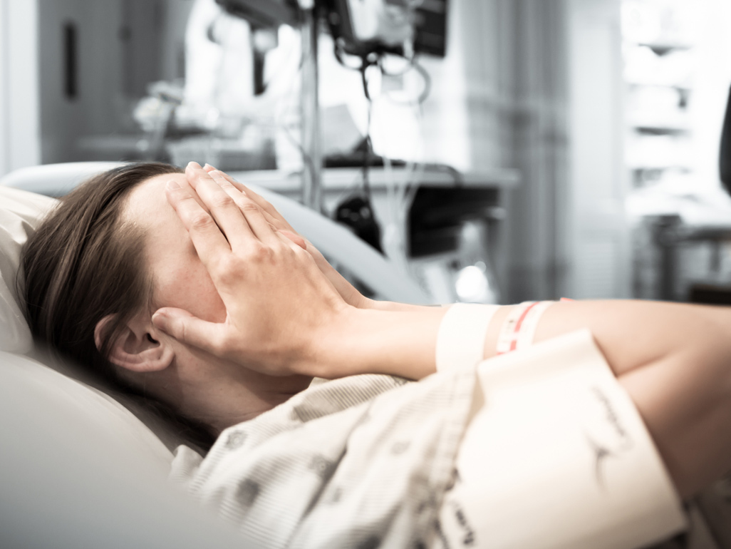 Mum-to-be in hopsital with her face in her hands